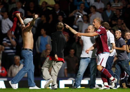 West Ham’s Jack Collison exhorts fans to return to the stands after a pitch invasion at their League Cup tie against Millwall in 2009.