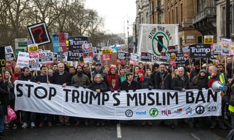 Thousands of protesters with banners and placards march through central London.