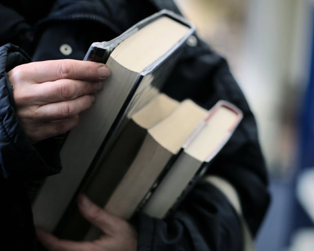 A man thumbing books