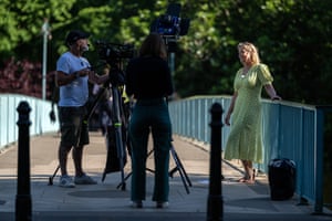 A weather presenter speaks to the camera during a broadcast from St James’s Park in London on June 15