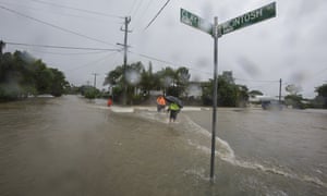 Residents walk through floodwaters in Hermit Park, Townsville