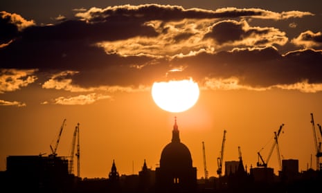 Sunset on a summer evening over St Paul’s cathedral in London. The UK’s average temperature is currently cooler than 13C, meaning the economy may improve a little as temperatures rise. 