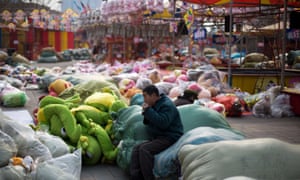 Migrant workers take lunch break on the bags of soft toys dismantled from the stores in China.