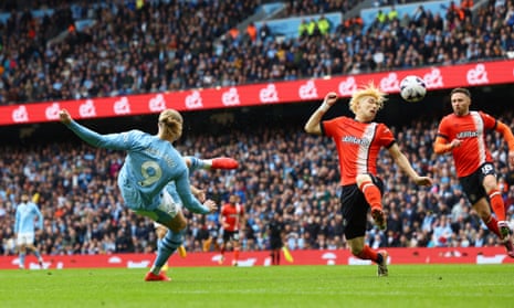 Manchester City’s Erling Haaland’s shot hits the fizzog of Luton Town’s Daiki Hashioka and goes into the net to give the home side the lead.