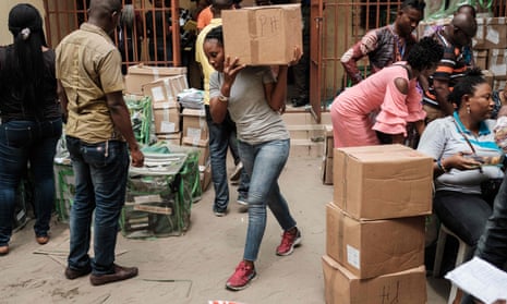 An electoral commission staff member carries a box of ballot papers in Port Harcourt, Nigeria