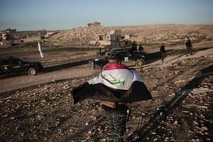 Mosul, IraqA member of the Iraqi federal police wears a flag around his shoulders before going to battle against Isis