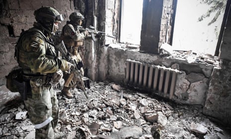 Russian soldiers in a ruined room of Mariupol drama theatre.