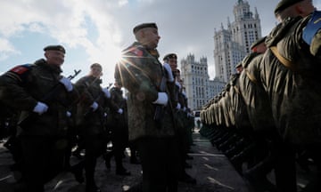 Russian service members march in columns on Victory Day.
