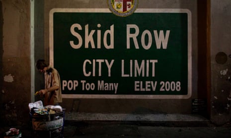 A homeless man takes food from a rubbish bin in Los Angeles’ Skid Row area