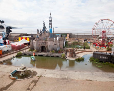 Dismaland, create to look like an abandoned theme park with a castle, ferris wheel and lake filled with a murky, green liquid