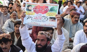Supporters of Mumtaz Qadri hold placards bearing slogans expressing opposition to Pakistan’s supreme court verdict on Wednesday.