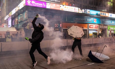 A Hong Kong protester throws a tear gas canister on October 27, 2019