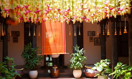 Chains of flowers hang from the ceiling of a hotel