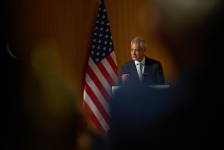 A man in a suit and tie speaks at a lectern
