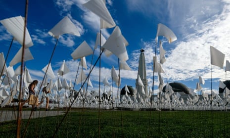 A Covid-19 memorial made of white flags representing lives lost to coronavirus is set on the lawn of the Griffith Observatory in Los Angeles.
