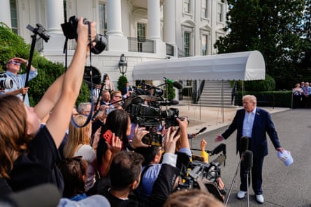 Donald Trump fields reporters outside the White House