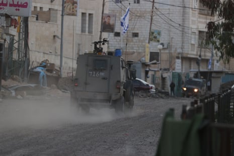 Military vehicles are seen on a street as the Israeli raids and attacks on Jenin city and its refugee camp continue in Jenin, West Bank on Tuesday.