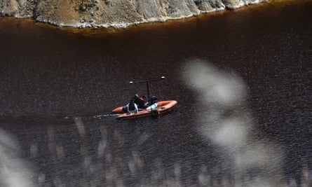 A boat equipped with a sonar system crosses the Red Lake in an effort to find evidence.