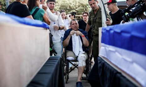 Avida Bachar, Dana’s husband and who was injured in the attack on the kibbutz and has since had his leg amputated, weeps.