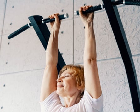 A woman hanging from bars