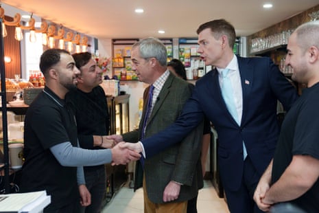 Goodwin shakes hands with staff in a cafe
