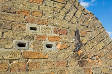Three swift bricks with cavities in wall of a stone cottage