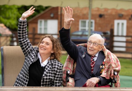 Tom Moore and his daughter, Hannah, celebrate his 100th birthday in April 2020, the month he achieved his fundraising goal of walking 100 laps around his garden.