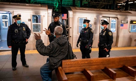 New York police officers clear the platform of passengers at the last stop at the Coney Island station in Brooklyn, New York, on 6 May.