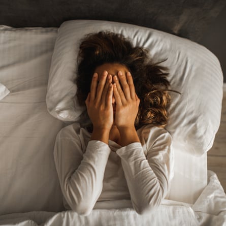 Woman struggling to sleep in a heatwave