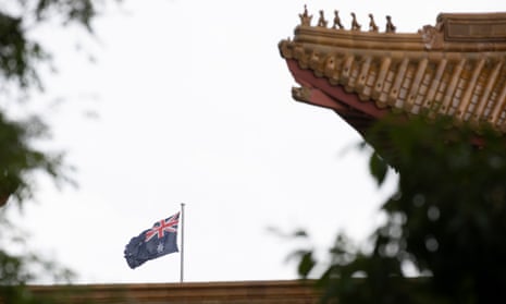 File photo of the flag on top of Parliament House seen over the roof of the Chinese embassy in Canberra