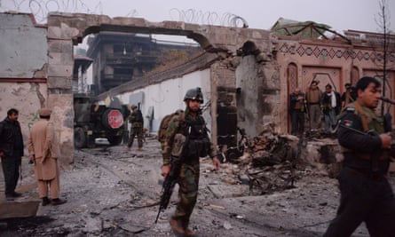 Afghan security forces inspect the site of the attack on British charity Save the Children’s office