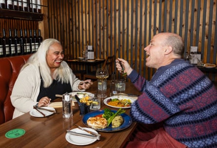 Maxine and Fred chatting and laughing at a restaurant table
