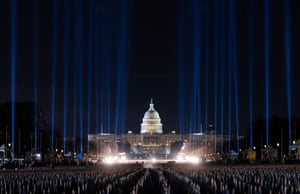 Washington, DC, US: a lightshow forms a backdrop to the Field of Flags, made up of more than 200,000 flags installed in front of the Capitol building to represent people who are unable to attend the upcoming presidential inauguration