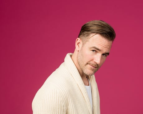 portrait of person wearing white knit jacket posing against pink background