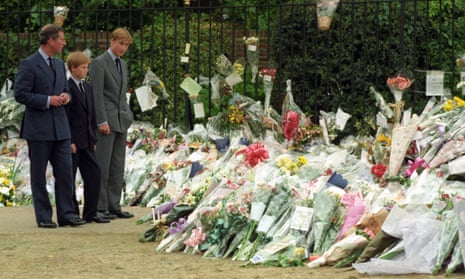 Prince Charles, William (right) and Harry view floral tributes to the Princess of Wales at Kensington Palace after her death in 1997.