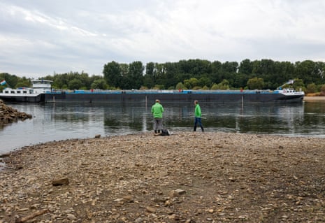 A ship passes by as members of Greenpeace take water samples during prolonged dry weather across Europe that has left the Rhine River at near-record low levels, disrupting German industries,, near Monheim, Germany, on 19 August.