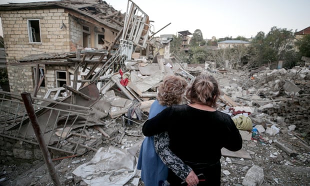 Two women embrace as they examine the ruins of a residential house destroyed in a shelling attack in Stepanakert, Nagorno-Karabakh