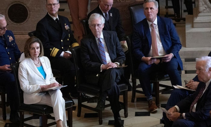 Mitch McConnell, center, with House Speaker and Democrat Nancy Pelosi to his right and Kevin McCarthy, House minority leader, to his left, at an event on Capitol Hill yesterday.