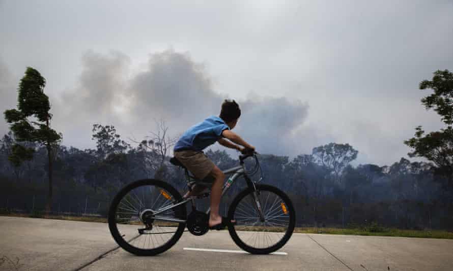 A boy rides a bike in the sun