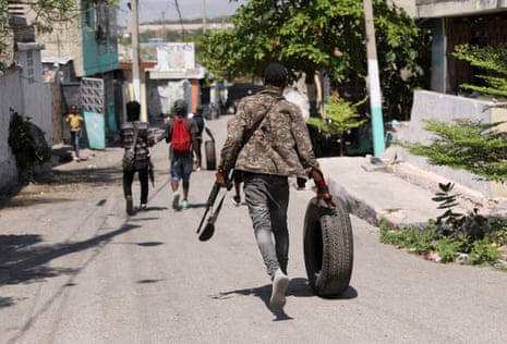 A gang member walks through Port-au-Prince, Haiti, on 11 March 2024.