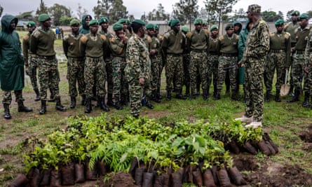 Members of the National Youth Service receive instructions before handling tree seedlings.