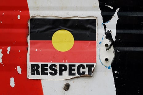 A sticker of the Australian Aboriginal Flag along with the word “RESPECT” is pictured on a structure at the Aboriginal Tent Embassy