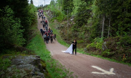 Han leads a procession through Nordmarka forest.