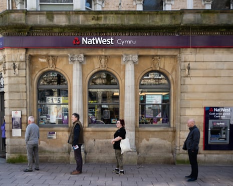 UK On Lockdown Due To Coronavirus Pandemic<br>CARDIFF, UNITED KINGDOM - MARCH 24: Customers queue outside Natwest bank, practising social distancing, on March 24, 2020 in Cardiff, United Kingdom. British Prime Minister, Boris Johnson, announced strict lockdown measures urging people to stay at home and only leave the house for basic food shopping, exercise once a day and essential travel to and from work Coronavirus (COVID-19) has spread to at least 195 countries, claiming over 16,500 lives and infecting over 380,000 people. There have now been 6,650 diagnosed cases in the UK and 335 deaths. (Photo by Matthew Horwood/Getty Images)