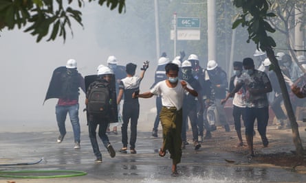 Anti-coup protesters clash with policemen and soldiers in Mandalay, Myanmar.