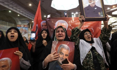 Iranian women holding pictures of Qassem Suleimani during the memorial ceremony.