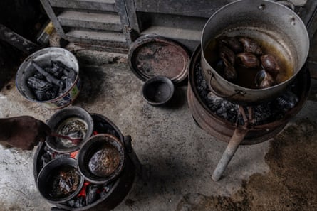 Metal pots and bowls filled with snails and liquid