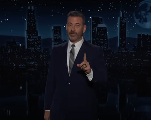 man in suit speaks with finger pointed