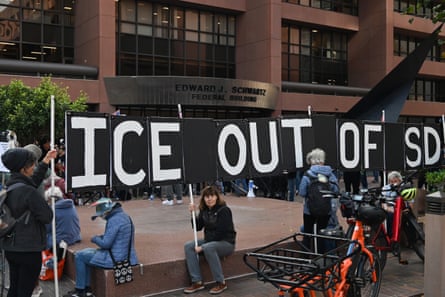 people hold a sign that reads ‘ice out of SD’