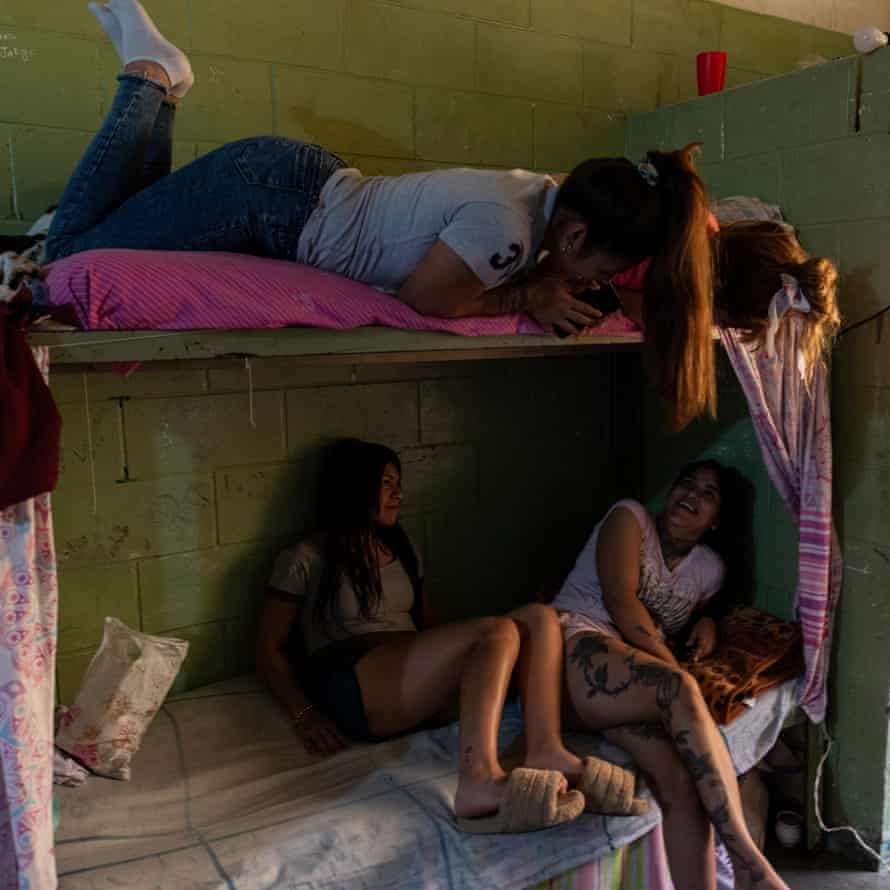 Detainees watch television in their cells